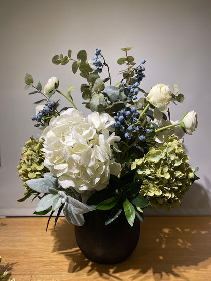 Hydrangeas & blueberries arrangement in ceramic vase
