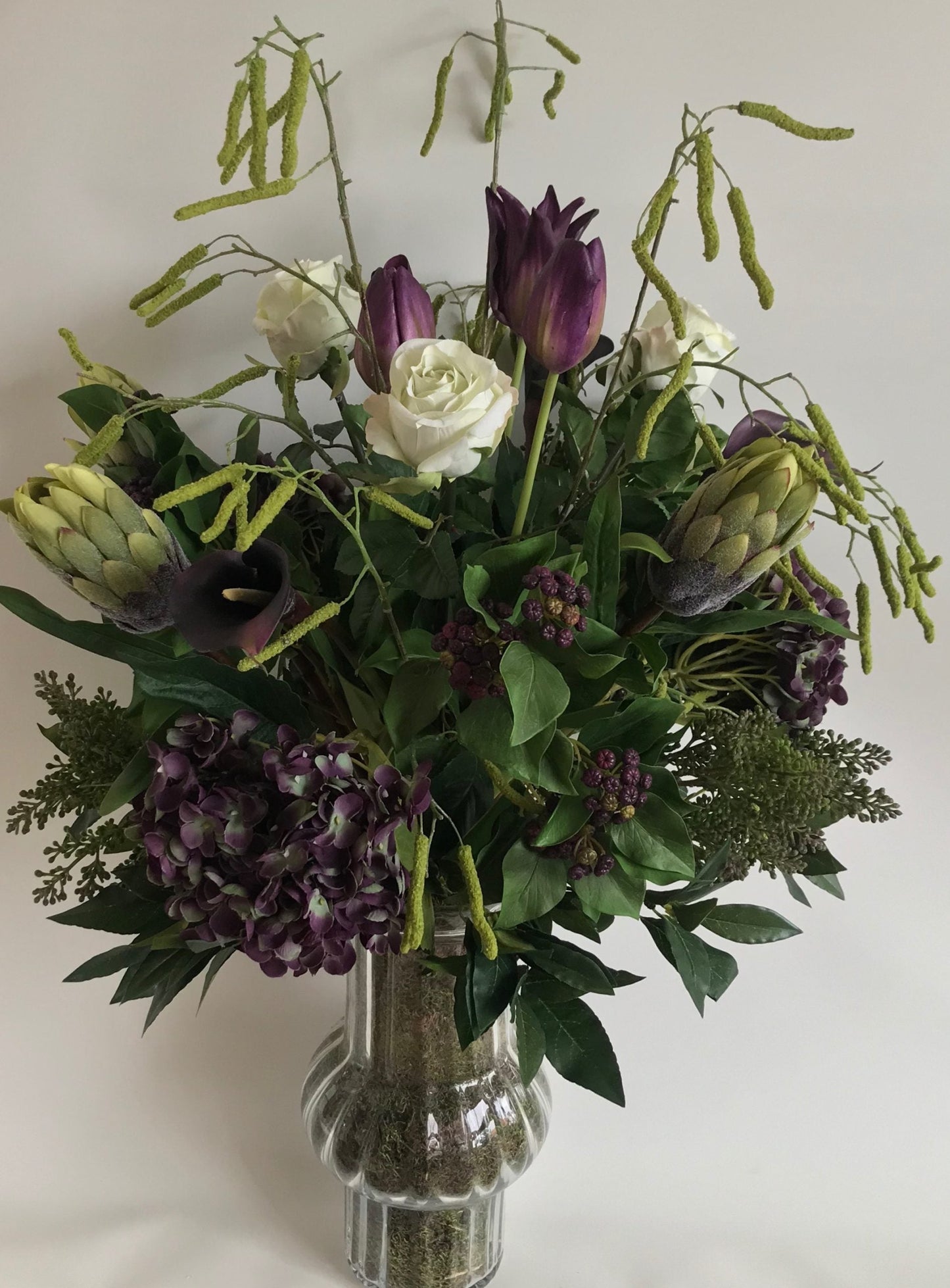 Sophisticated Green & Purple Flowers in Mossed Glass Vase